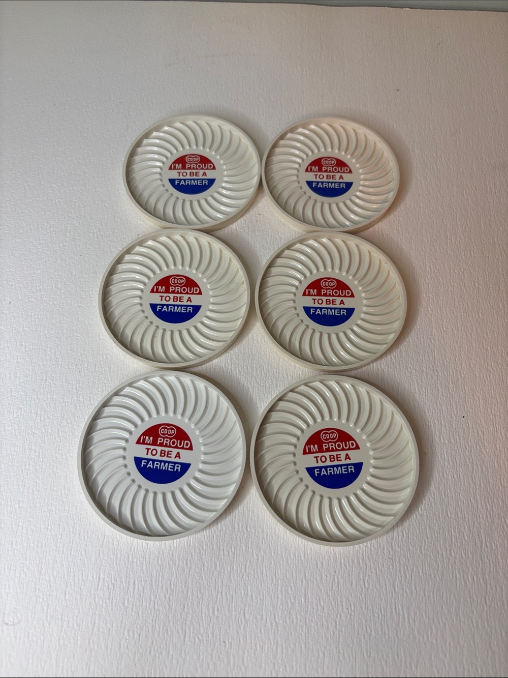 Vintage White Pinwheeel Molded Plastic Coasters COOP “I’m Proud To Be A Farmer”
